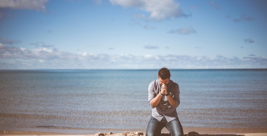 Praying On Beach